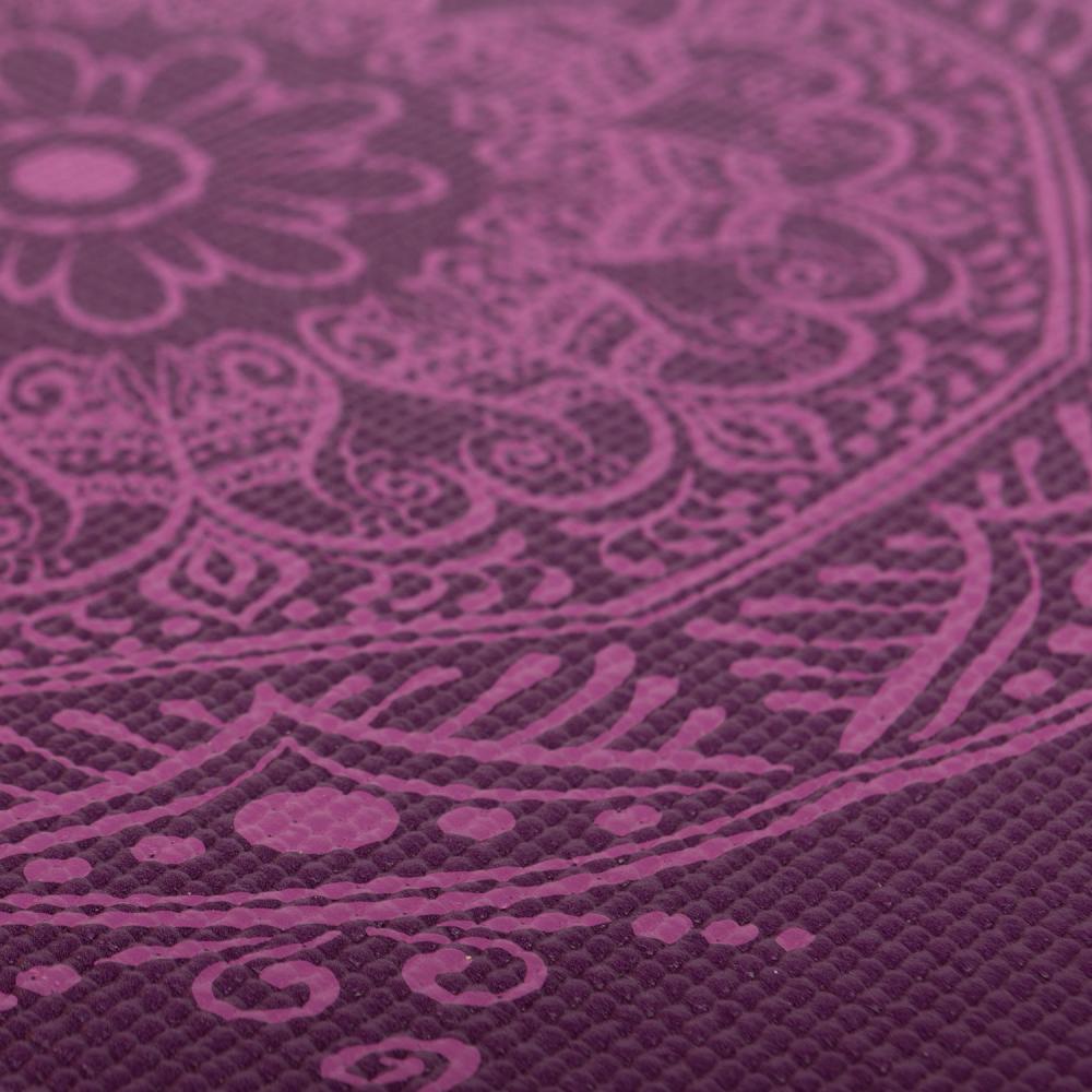 A close-up of a textured purple surface with a raised paisley and floral pattern in a slightly lighter magenta-purple tone.